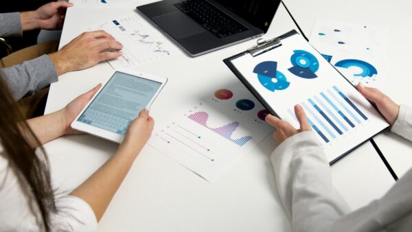 pexels-photo-5716032-5716032 Team analyzing financial charts and digital reports during a business meeting.