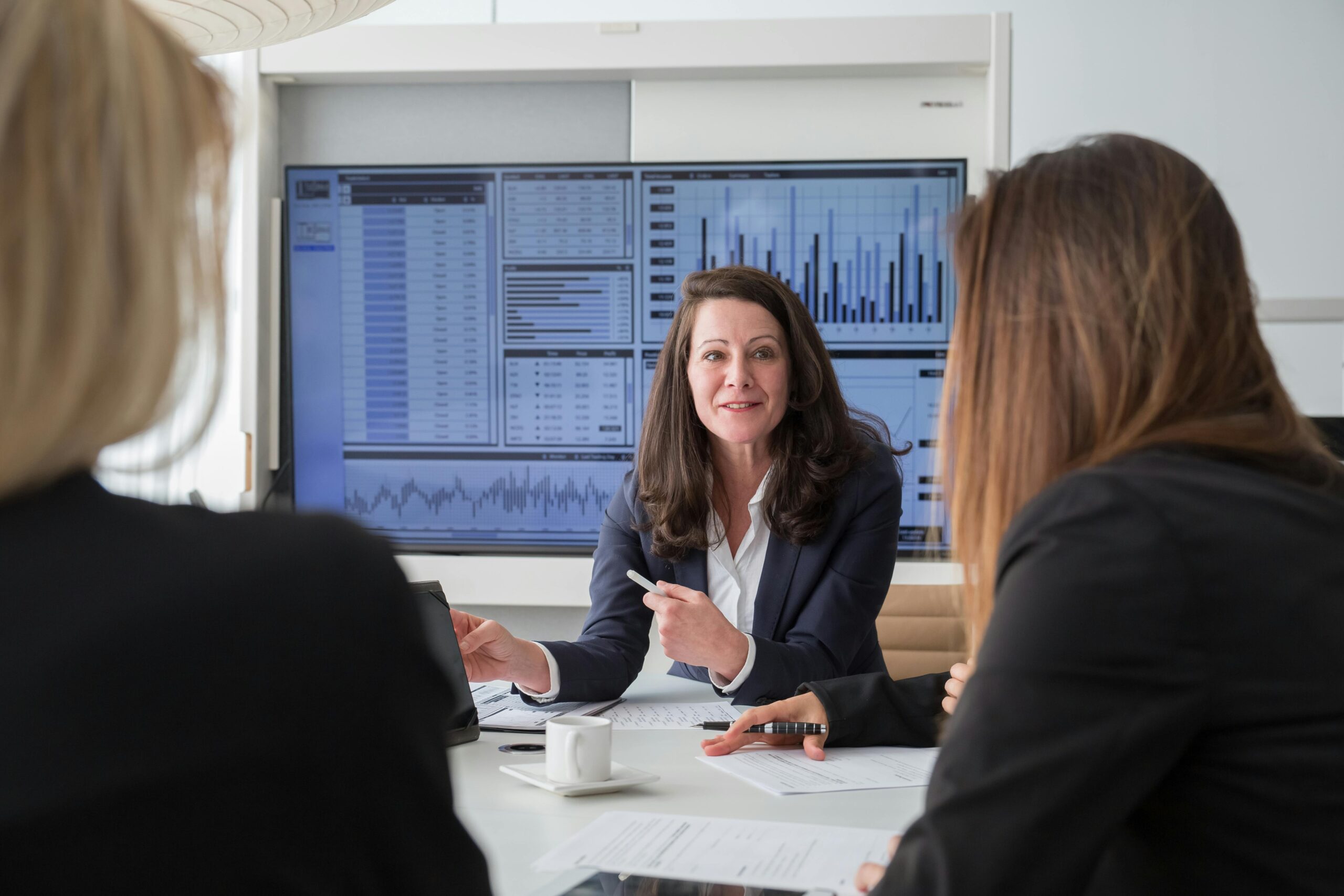 pexels-photo-8171188-8171188 Professional businesswomen engaged in a meeting discussing data on a screen.